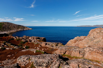 View of mountain lake and open ocean in tundra, Teriberka.