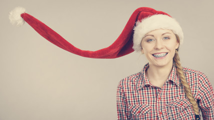 Happy woman wearing Santa Claus helper hat