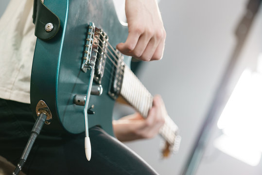 Close up of man playing on electric guitar