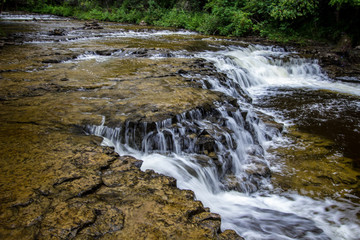 Fototapeta premium Ocqueoc Falls In Michigan. Ocqueoc Falls is Michigan bills itself as the only universally handicapped accessible waterfall in the United States. 