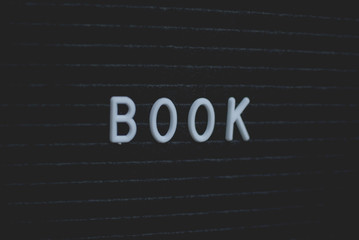 Word book written on the letter board. White letters on the black background. Business concept