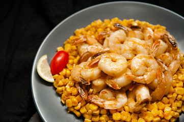 Grilled king prawns on dark plate
