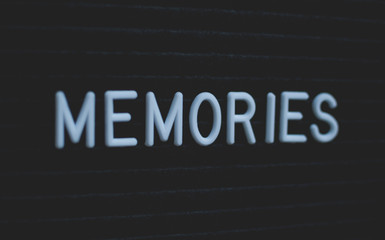 Word memories written on the letter board. White letters on the black background.