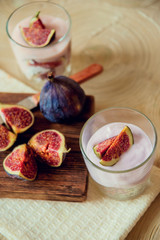 Autumn dessert in a jar with ripe figs and yogurt.