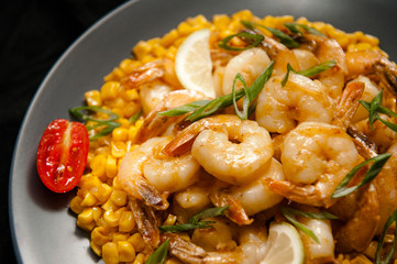 Grilled king prawns on dark plate