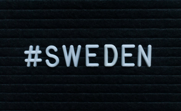 Hashtag word #sweden written on the letter board. White letters on the black background.