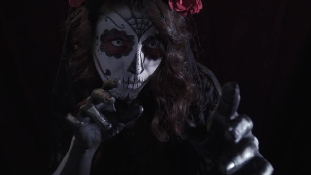 Mysterious girl in skull makeup, masquerade for halloween