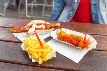German curry wurst sausage with french fries, street food concept