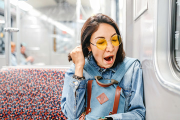 sleepy woman yawn in train or metro, sleepless and insomnia concept
