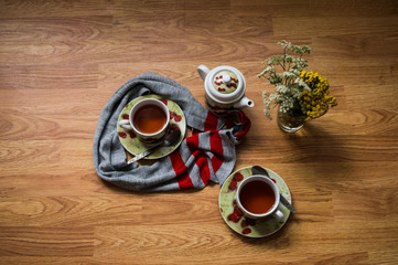 Tea ceremony, filled tea in service with wildflowers on the wood texture