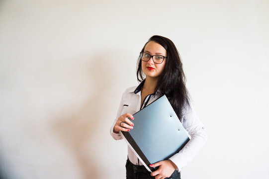 Business lady in glasses for sight with red lipstick on lips, stands on a white background with a folder of papers and conducts business negotiations about a financial project