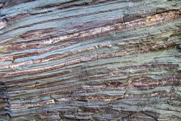 Iron Ore Rock. Bands of iron in raw form create colorful layers in a boulder,