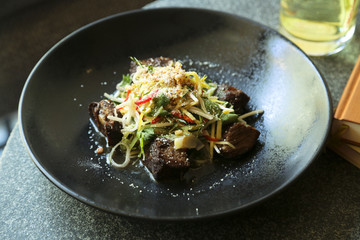 Braised beef checks with Asian style salad