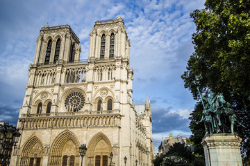 Naklejka na ściany i meble Notre Dame Cathedral with a blue sky on the background