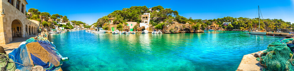 Panoramic view of old fisher village and boats at bay coast of Mallorca island - obrazy, fototapety, plakaty