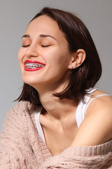 Happy smiling lady showing her teeth with braces