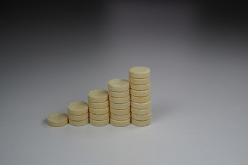 columns of yellow tablets in the form of an ascending chart