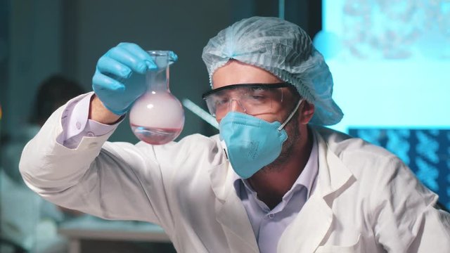 Man professor conducts chemically experience