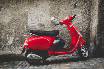 Fototapeta na wymiar Red scooter parked on a street in Bern Switzerland