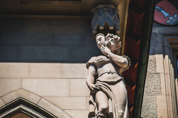 Statue of the right side of the Town hall building (Rathaus) of Bern Switzerland that depicts lie and cowardice
