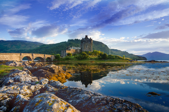 Tourists favourite place in Scotland - Isle of Skye. Very famous castle in Scotland called Eilean Donan castle.  Top of the mountains.Scottish Highlands. Castle with reflection in the lake.