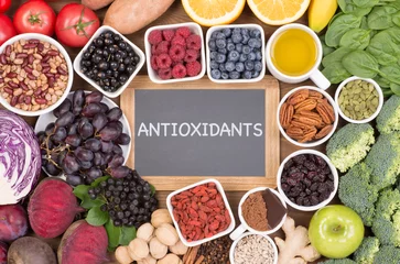 Poster Food sources of natural antioxidants such as fruits, vegetables, nuts and cocoa powder. Antioxidants neutralize free radicals © photka