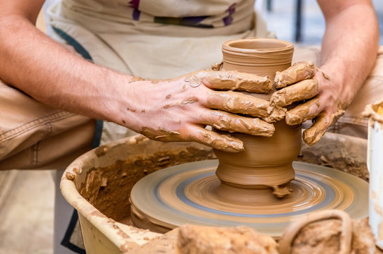 Pottery artist making clay pot in a workshop