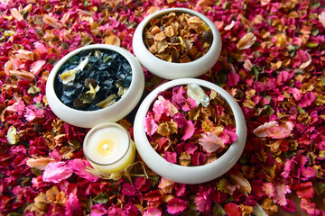 Potpourri or dried petals flowers colorful and scented candles
