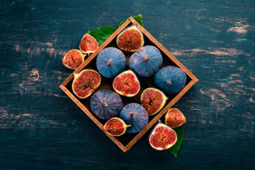 Fig. Fresh fruit figs in a wooden box. Free space for text. Top view.