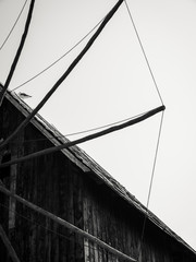 Old wooden windmill in the background of the blue sky