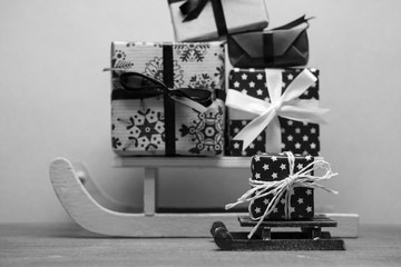 black white big and small christmas sledges with presents