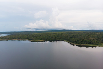 Drone shot Aerial view landscape scenic of big river reservoir with nature forest and mountains in tropical land