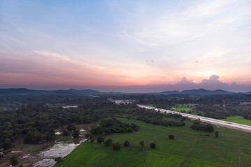 Fototapeta na wymiar Drone shot Aerial view landscape scenic of rural agriculture rice field with evening sunset atmosphere