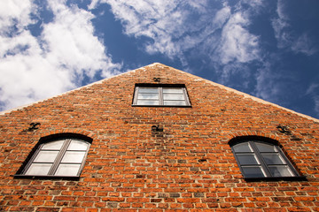 An old brick facade with windows and intricate details 
