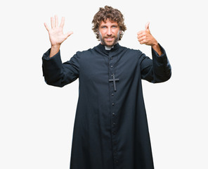 Handsome hispanic catholic priest man over isolated background showing and pointing up with fingers...