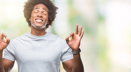 Afro american man over isolated background relax and smiling with eyes closed doing meditation gesture with fingers. Yoga concept.