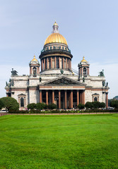 Fototapeta na wymiar St. Petersburg on a summer morning. View of the facade of Saint Isaac's Cathedral or Isaakievskiy Sobor (architect Auguste de Montferrand) from the park with a green lawn