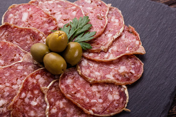 Saucisson sec delicious french salami on a wooden background