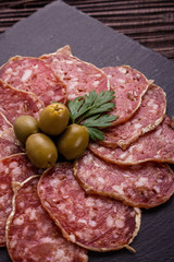 Saucisson sec delicious french salami on a wooden background