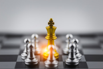 Gold king in chess game with Concept for company strategy,business victory or decision the path to success.