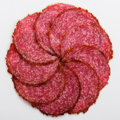 delicious sliced salami on a white background