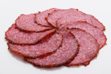 delicious sliced salami on a white background