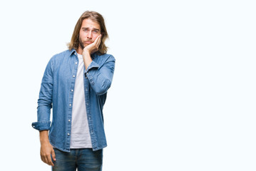 Young handsome man with long hair over isolated background thinking looking tired and bored with depression problems with crossed arms.