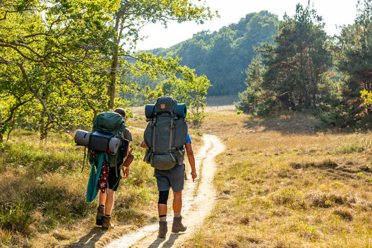 Two young hikers walking on a lonesome path through &Ouml;sterlen, Scania, Sweden