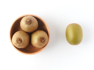 Top view of ripe fresh kiwifruits on wooden bowl isolated on white background. Fruit, nature, health and nutrition concept. Summer food.Copy space. One contrast with a group.