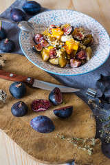 Yummy healthy tropical fruit salad for breakfast. Appetizer, vegan vegetarian dieting food. Fruits and berries. Apples, pears, figs, dates, bananas.