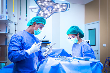 Team surgeon at work in operating room.