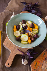 Steamed cooked vegetables stew (zucchini, pumpkin, cauliflower) in a big ceramic bowl with fried chestnuts. Dieting vegan lunch, non-gluten nuts, vegetarian dinner, healthy food concept 
