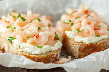 Prawns, shrimp seafood bruschetta with creamy cheese, parsley and chili