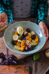 Woman hands holds steamed cooked vegetables stew (zucchini, pumpkin, cauliflower) in a big ceramic bowl with fried chestnuts. Dieting vegan lunch, non-gluten nuts, vegetarian dinner, healthy food 